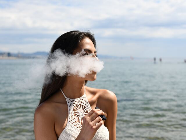 person vaping at the sea